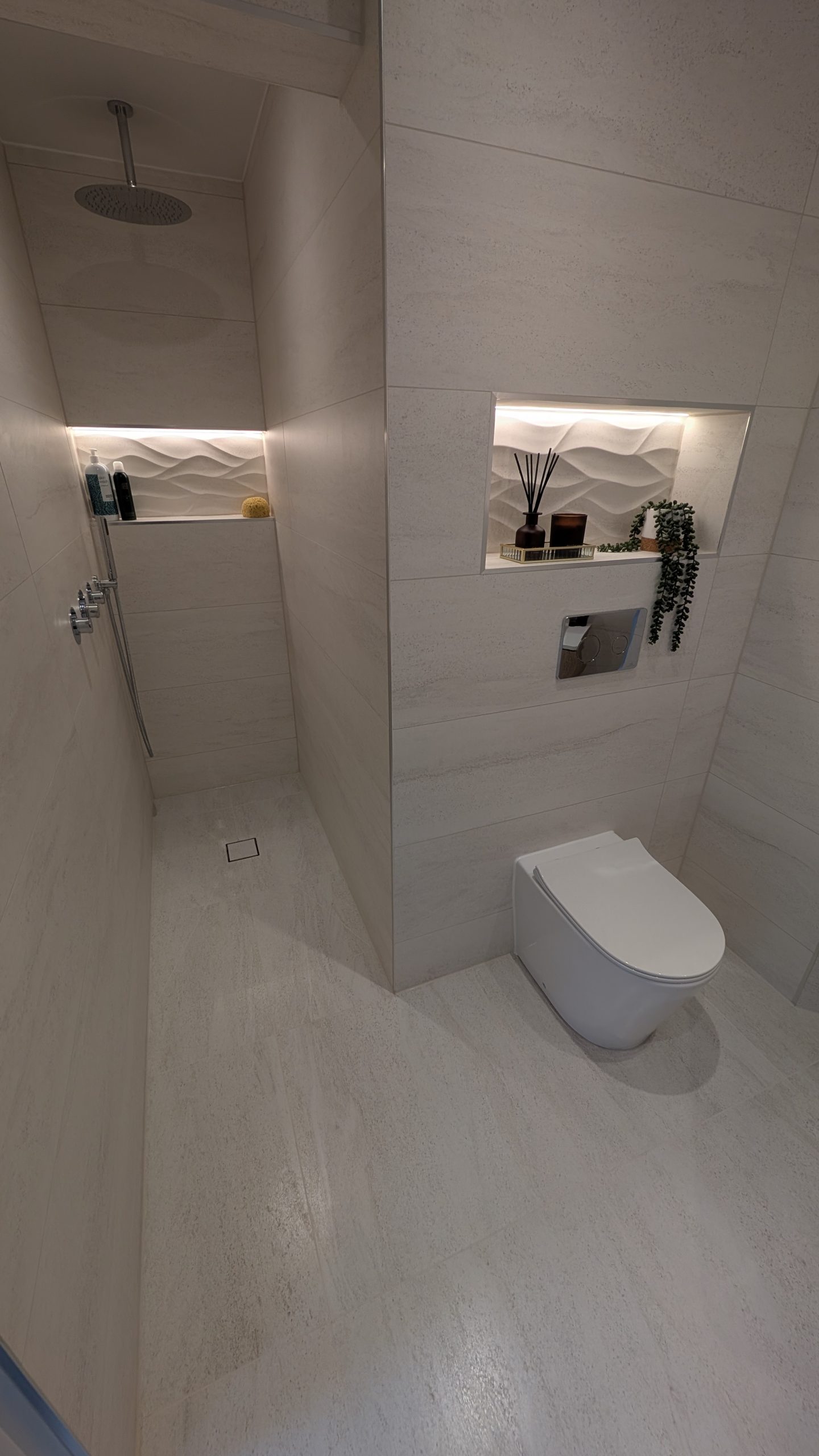 Walk-in wet room with lit niches fitted by Clan Bathrooms