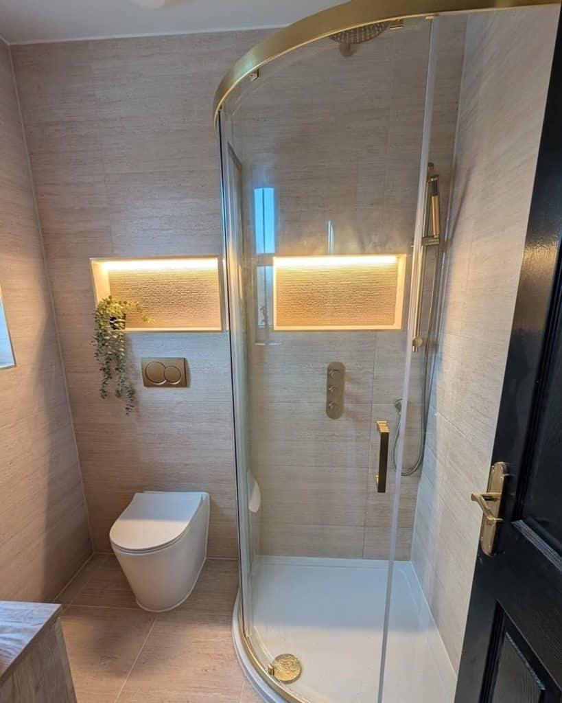 En-suite in Paisley with quadrant shower, LED-lit niches, back-to-wall toilet and brushed brass fittings